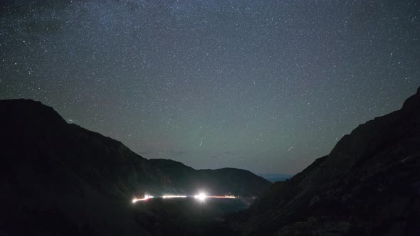 Night time lapse of a road winding through the mountains