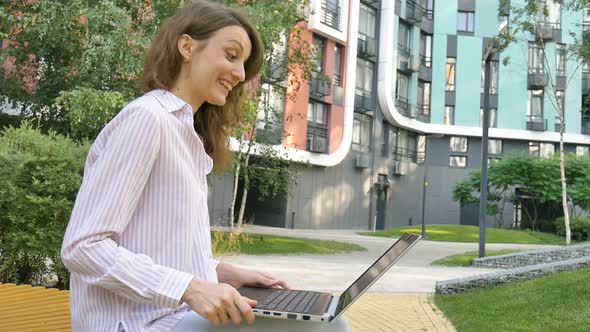 Young Woman is Having Online Meeting Using Her Laptop Businesswoman with Digital Tablet Outside on