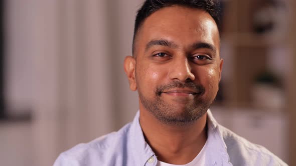 Portrait of Smiling Indian Man with Beer at Home