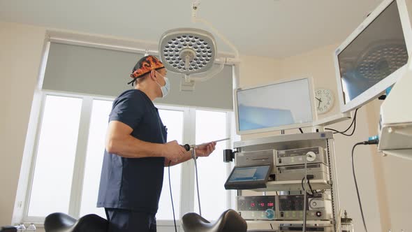 Portrait of a Focused Doctor Holding a Laparoscopic Instrument Looking at the