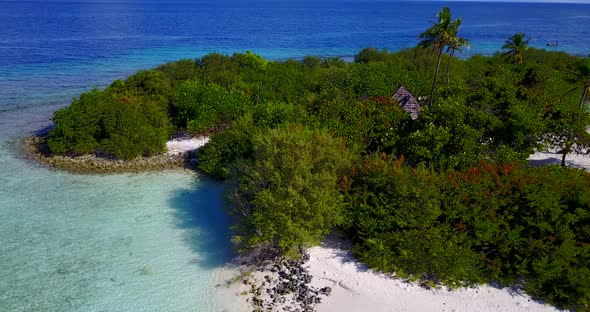 Beautiful birds eye abstract shot of a sandy white paradise beach and turquoise sea background in 4K