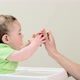 Baby boy sitting in highchair being fed - VideoHive Item for Sale