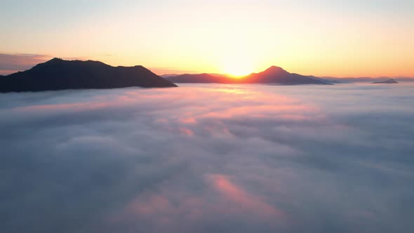 4K Aerial view flying in fog. clouds at sunset fog.