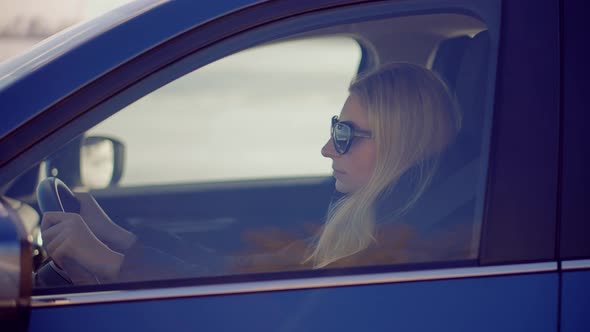 Woman Driving Turning Steering Wheel In Car. Female Driver In  Auto. Woman Driving On Automobile.