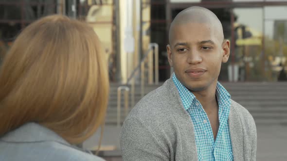 Handsome Cheerful African American Man Talking To a Friend Outdoors