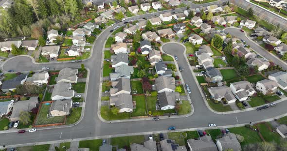 Medium overhead aerial shot of a standard cookie cutter neighborhood in North America.