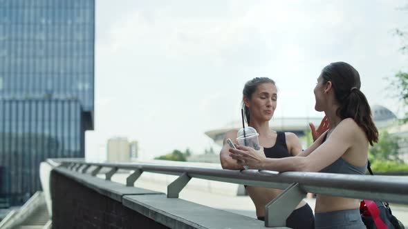 Video of two athletic women talking before training. Shot with RED helium camera in 8K. 