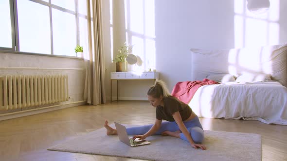 Young Woman in Prepares for Workouts on the Internet