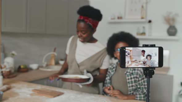 African American Mother and Son Recording Video Recipe of Apple Pie