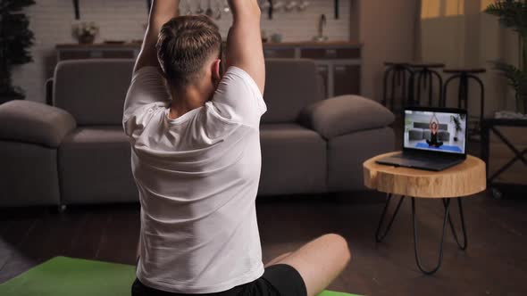Athletic Male Doing Yoga in Lotus Position Indoors