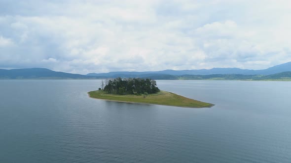 View of Lake Island with Green Grass and Trees in The Summer