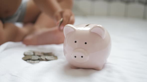 Family Putting Coins Into Piggy Bank for the Future Savings.