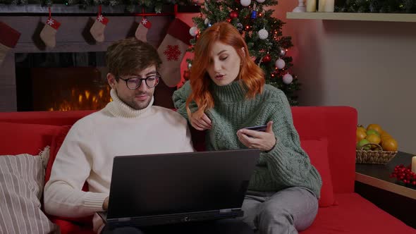 A family using laptop and credit card buying online.