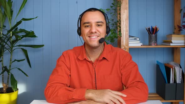 Young Man in Headset with Microphone Holding Online Meeting Conversation