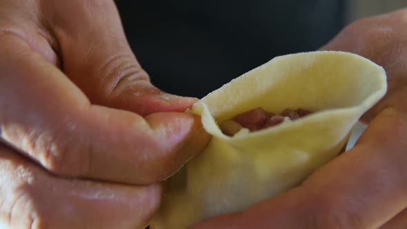 Macro Cook Hands Model Patty with Filling on Dough Circle