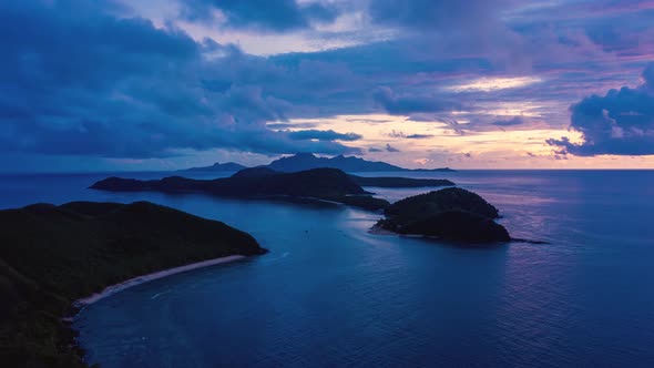 Hyperlapse of an incredible purple sunset over exotic islands in Pacific Ocean alt