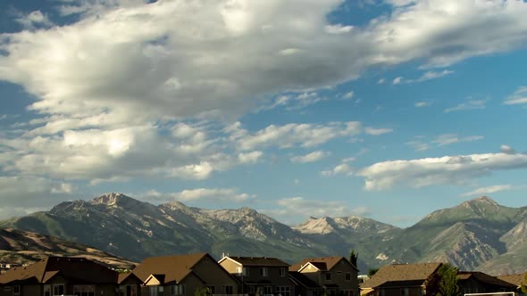 Time lapse of a cloudscape above the Rocky Mountains then zooming out to reveal a wide angle view of