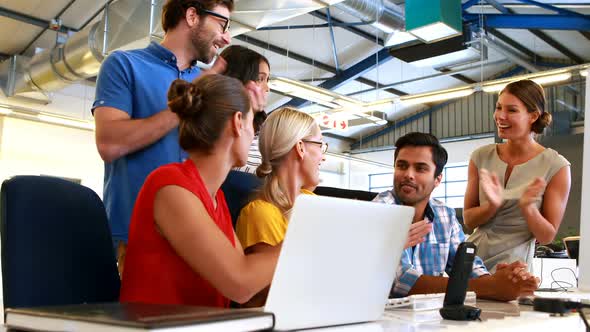 Businesspeople interacting and applauding