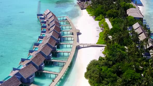 Aerial drone seascape of marine resort beach break by blue water with sand background