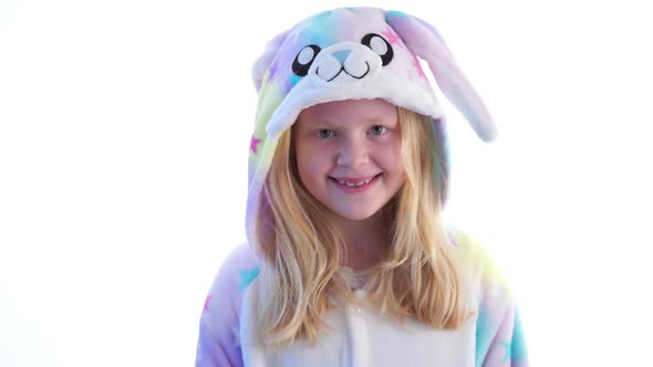 Beautiful Blonde Girl Posing on a White Background in Kigurumi Pajamas, Bunny