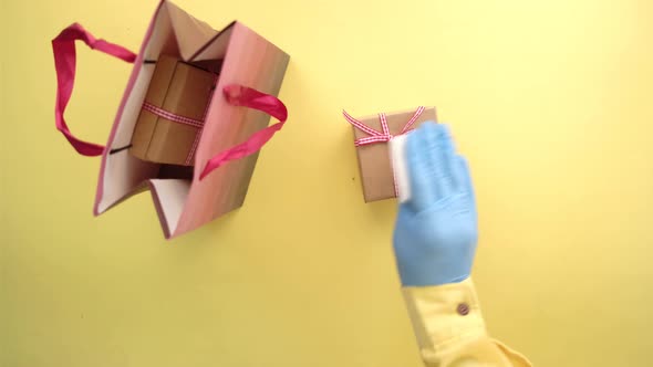 Hand in Latex Gloves Wapping a Gift Box with Tissue