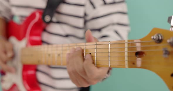 Slow motion close up musician playing the electric guitar during a live performance.
