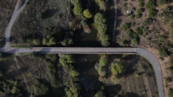 Roman stone bridge over Seda river, Vila Formosa in Portugal. Aerial top dawn descending