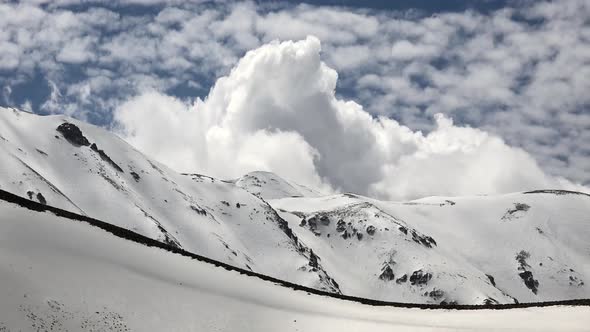 Snowy Mountain Ridge Under Thermal Ripple Created by Warm Air