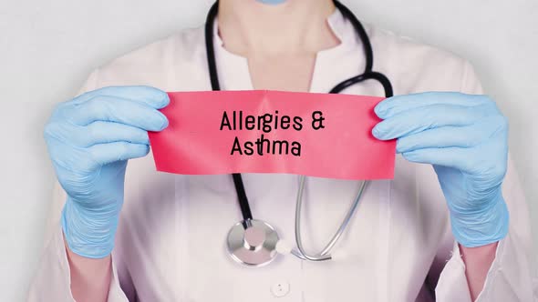 Closeup, Hands in Blue Medical Gloves Hold and Tear Red Paper Card with an Inscription Allergies alt