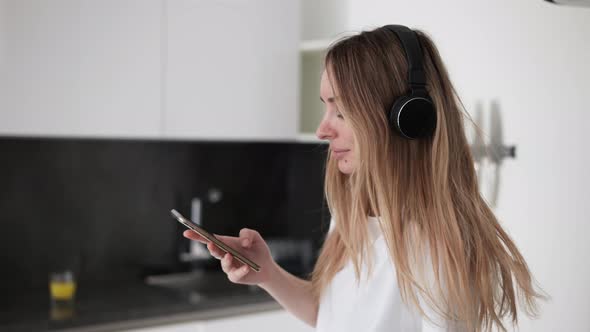 Woman Listening to Music in the Kitchen