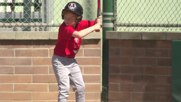 Kids playing little league baseball.