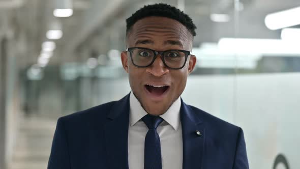 Portrait of Excited Young African Businessman Celebrating Success