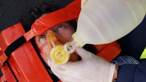 Emergency medical technician placing an oxygen mask