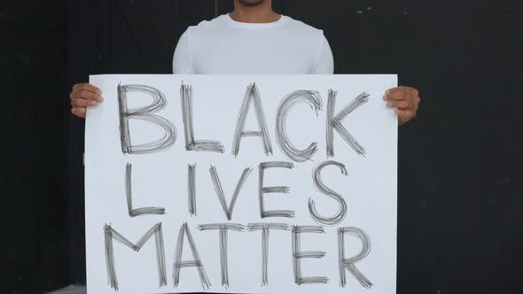 Poster BLACK LIVES MATTER in the Hands of a Black Man.