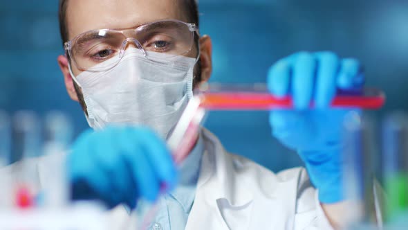 Doctor Wearing Protective Mask Making Science Experience with Blood Sample in Modern Laboratory