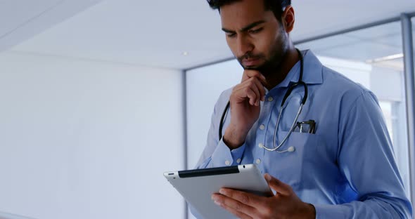 Male doctor using digital tablet