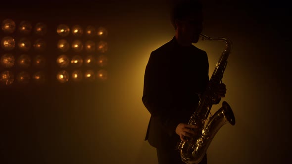 Silhouette Man Saxophonist Playing Instrument on Stage