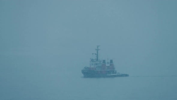 Boat Passing In Winter Snowstorm