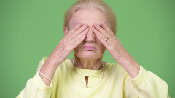 Beautiful Senior Businesswoman Covering Eyes As Three Wise Monkeys Concept