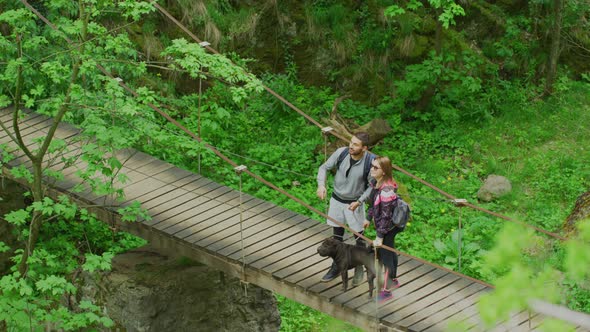 Couple on a bridge, pointing in a direction