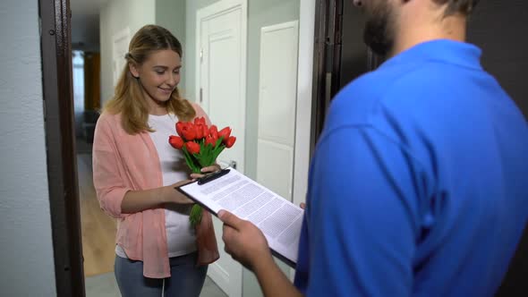 Courier Giving Bouquet of Flowers to Pretty Girl, Client Signing Delivery Order