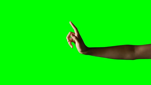 Person making hand gesture against green screen background