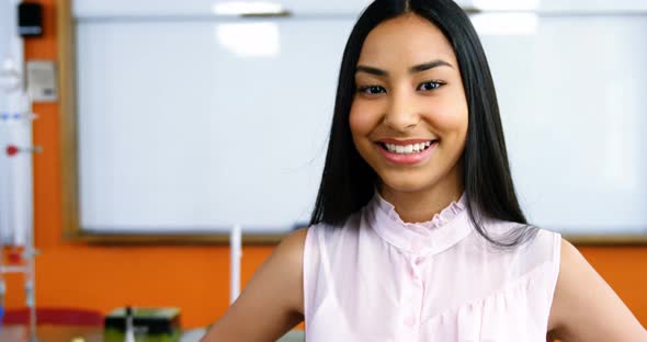 Portrait of smiling schoolgirl in classroom