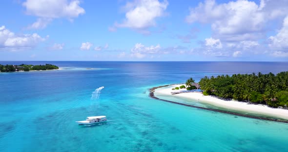 Luxury birds eye travel shot of a white sand paradise beach and blue sea background in colorful 4K