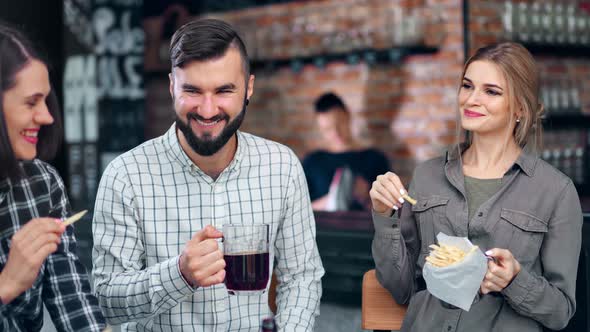 Young People Have Fun Laughing Talking Enjoying Weekend Party at Cozy Loft Restaurant Interior