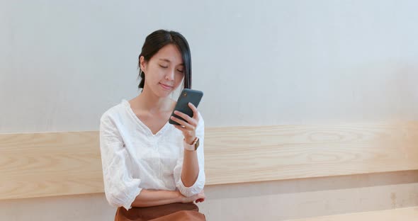 Woman use of smart phone inside coffee shop