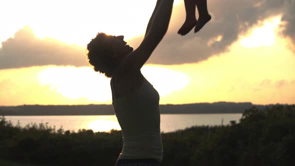 Silhouettes from Mother and Child Having Fun Together