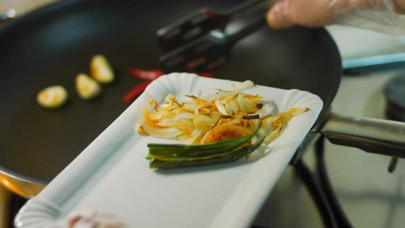 The Cook Removes the Browned Vegetables From the Wheat