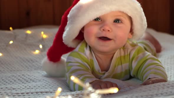 Smiling Baby Wearing Red Santa Claus Hat Celebrating Christmas