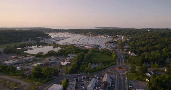 Flying Over Huntington and Towards Boats Docked at Bay During Sunset